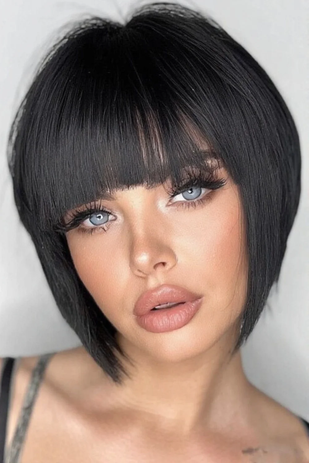 Pixie bob hairstyle with sharp, blunt bangs for impact. 