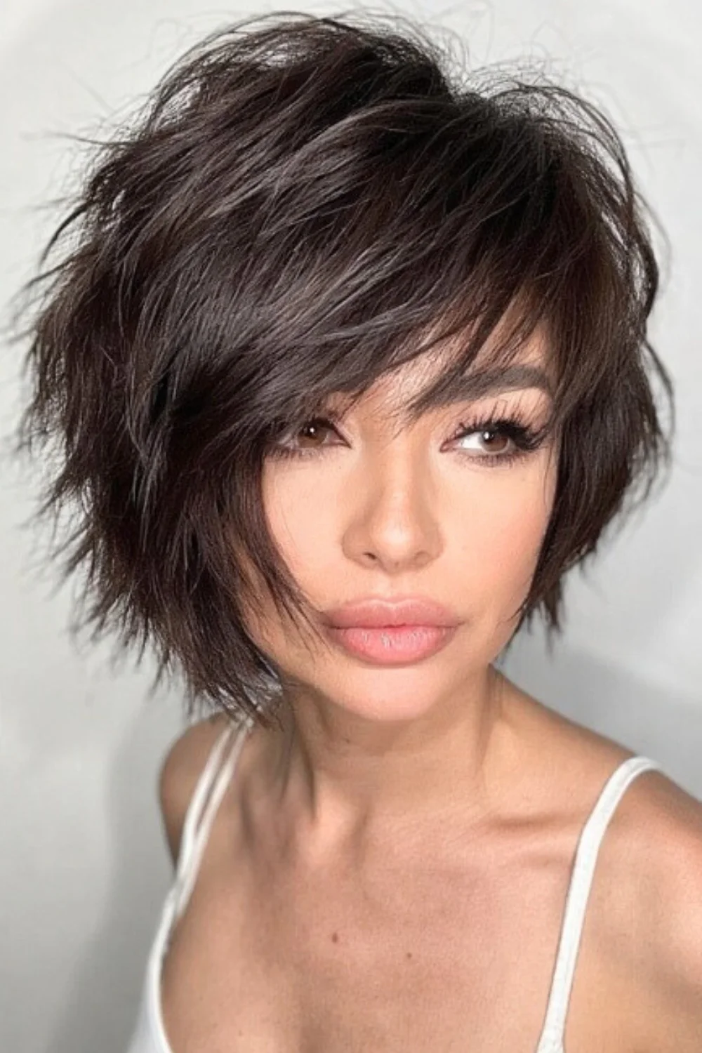 Pixie bob haircut styled with choppy, textured layers. 