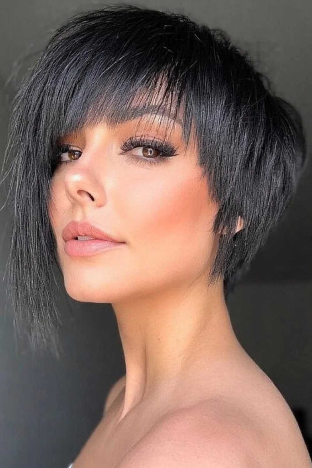 Edgy pixie bob hairstyle featuring a bold fringe. 