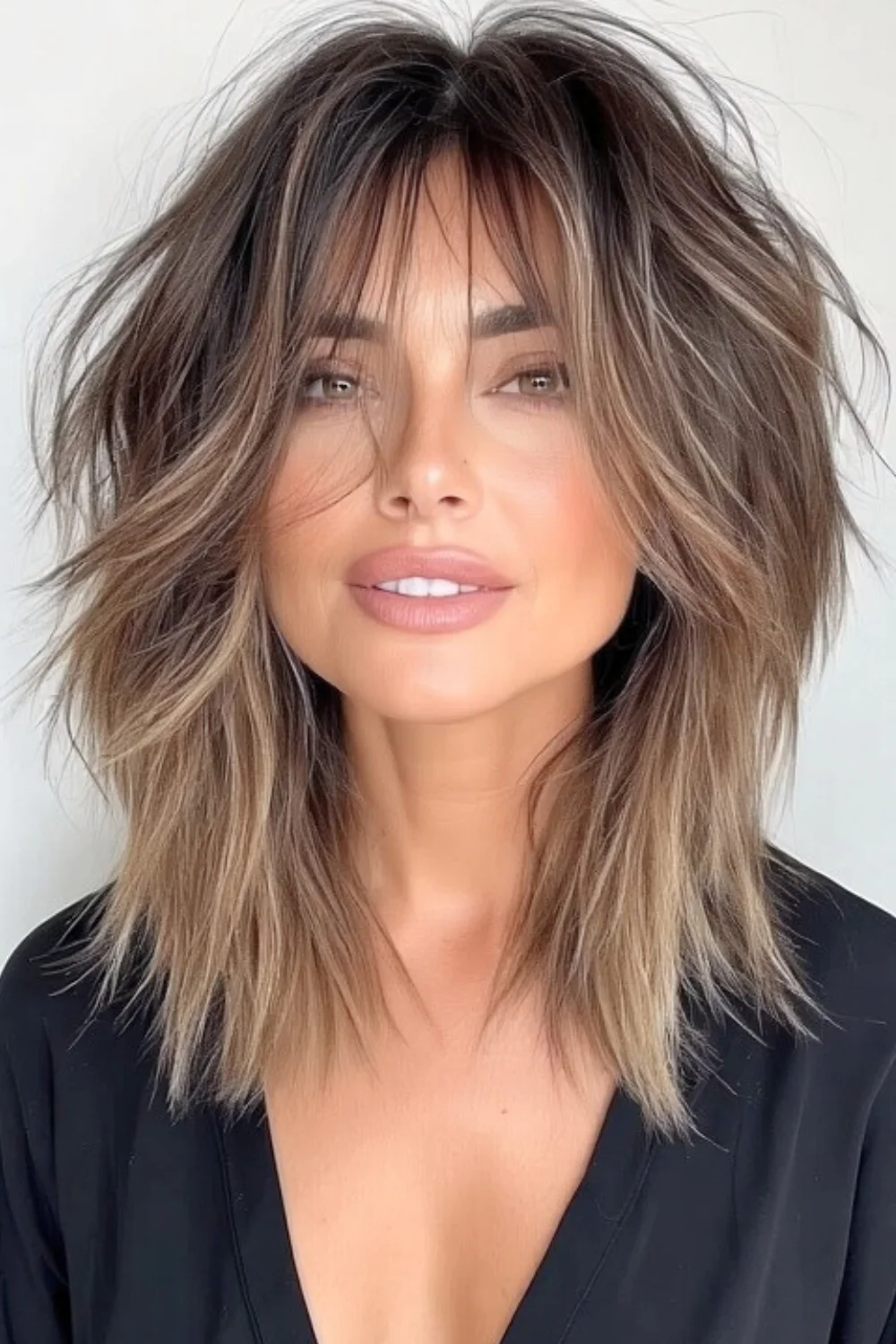 Layered hairstyle designed to accentuate and refine the jawline 