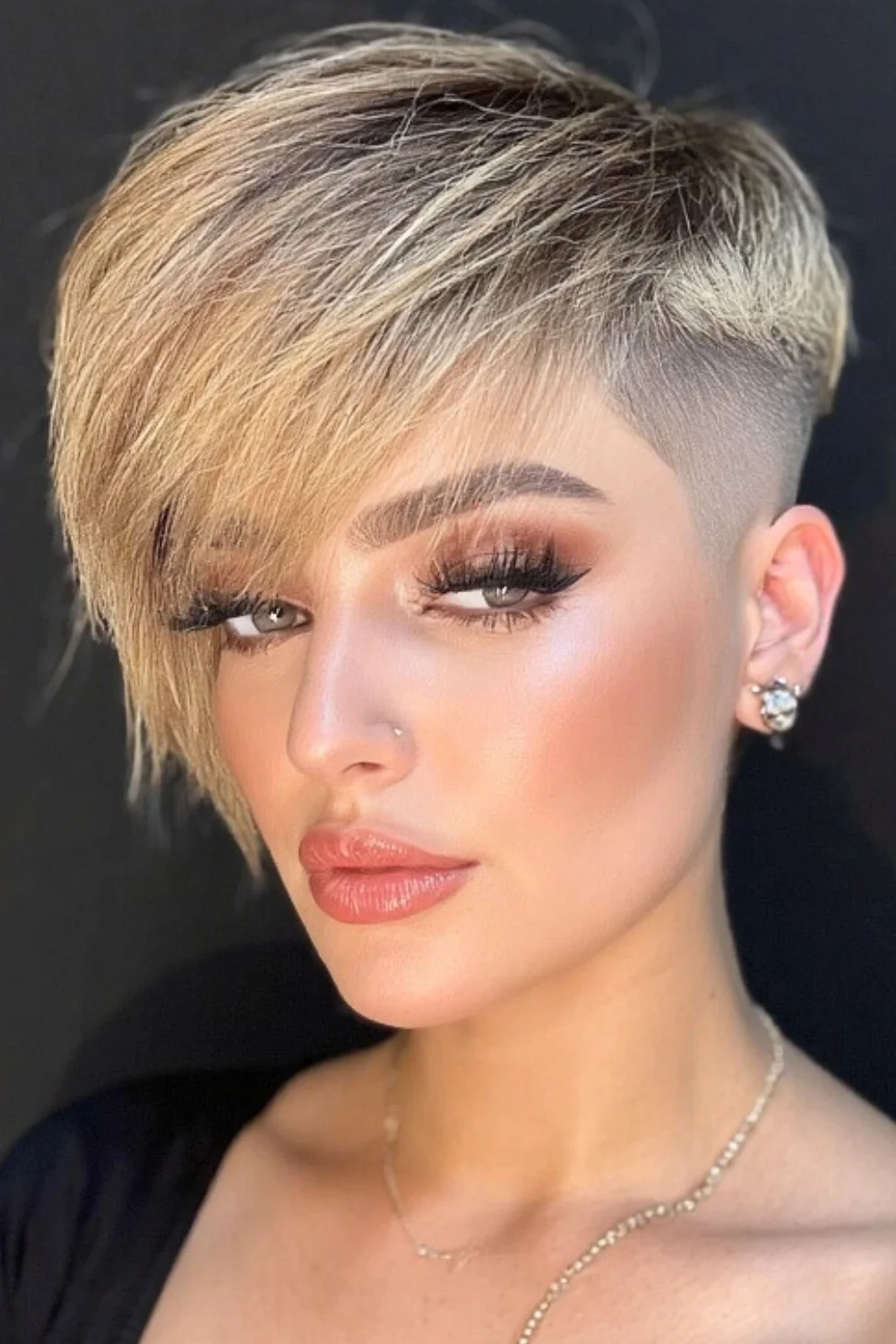 Trendy pixie bob haircut featuring a bold undercut 