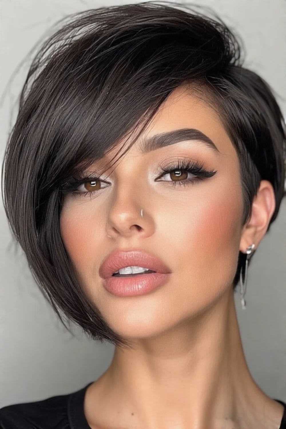 Pixie bob styled with a dramatic deep side part for modern flair 