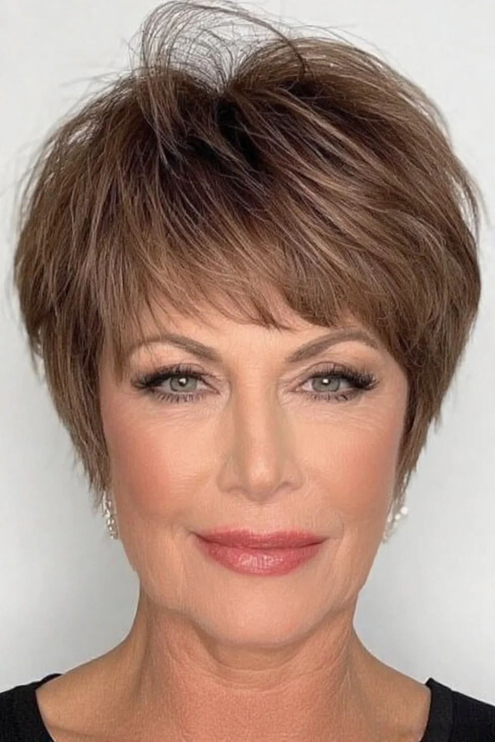 Pixie bob hairstyle featuring a sleek center part
