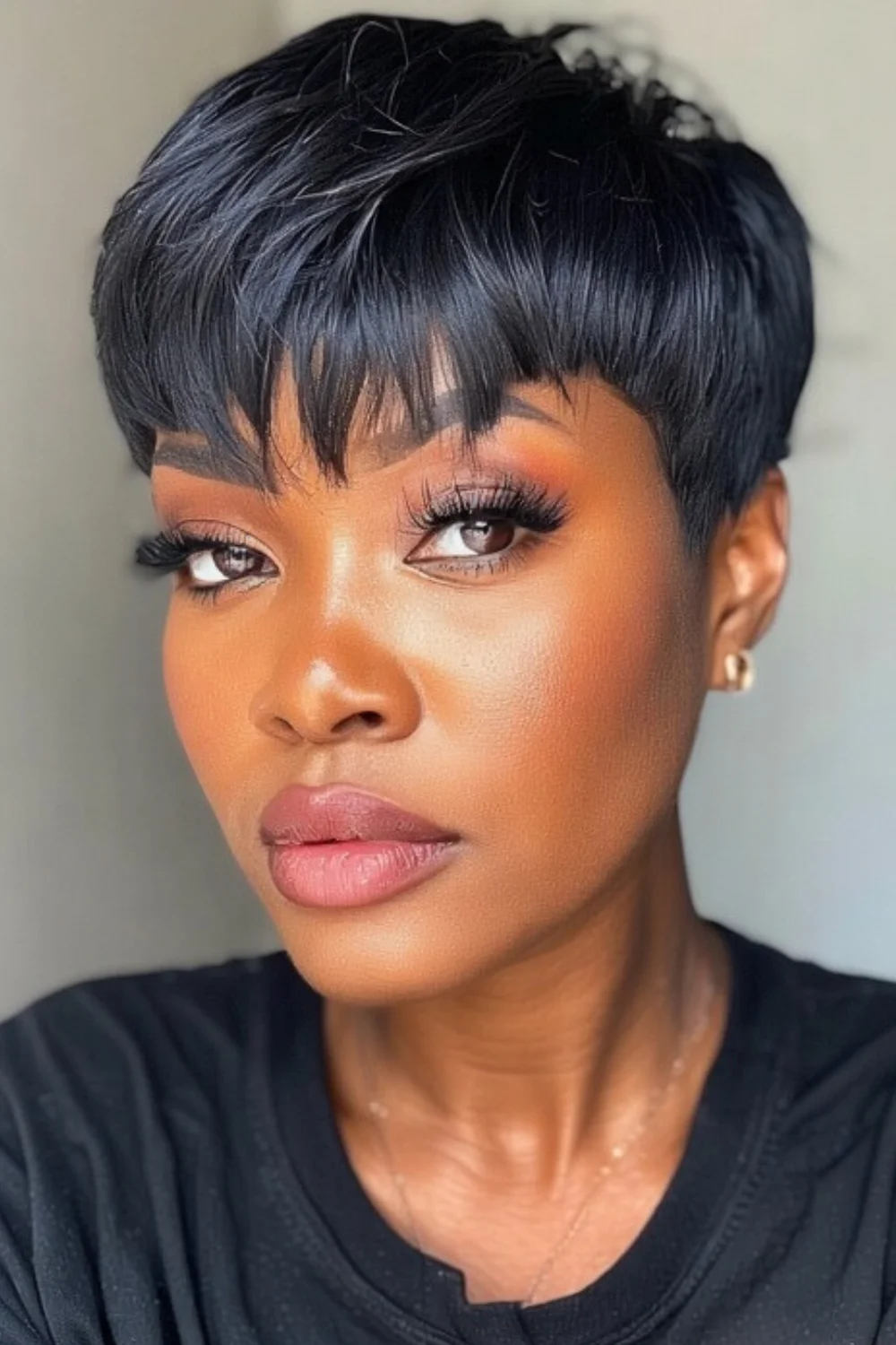 Short pixie cut hairstyle featuring soft bangs