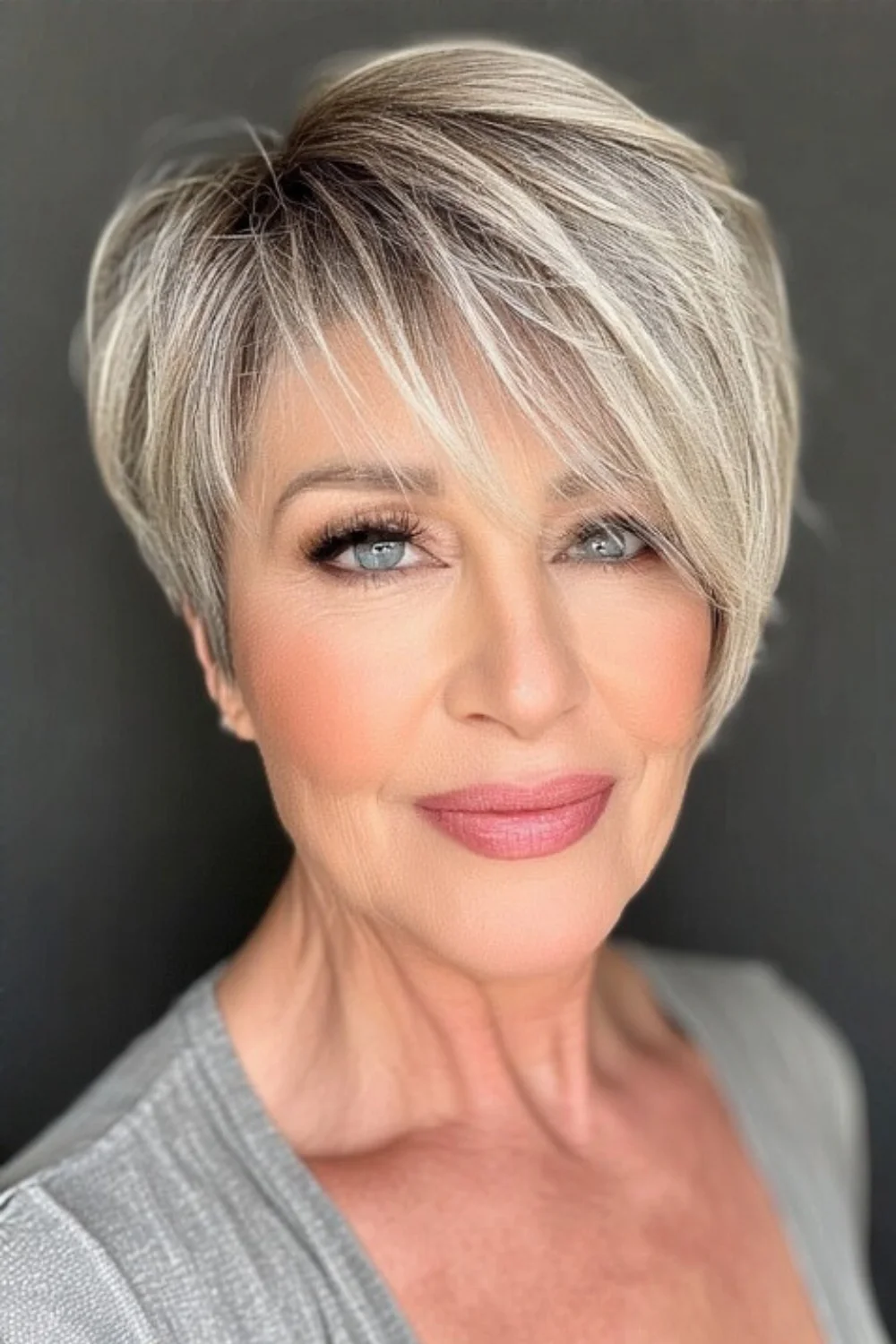 Pixie hairstyle with a side part and soft bangs