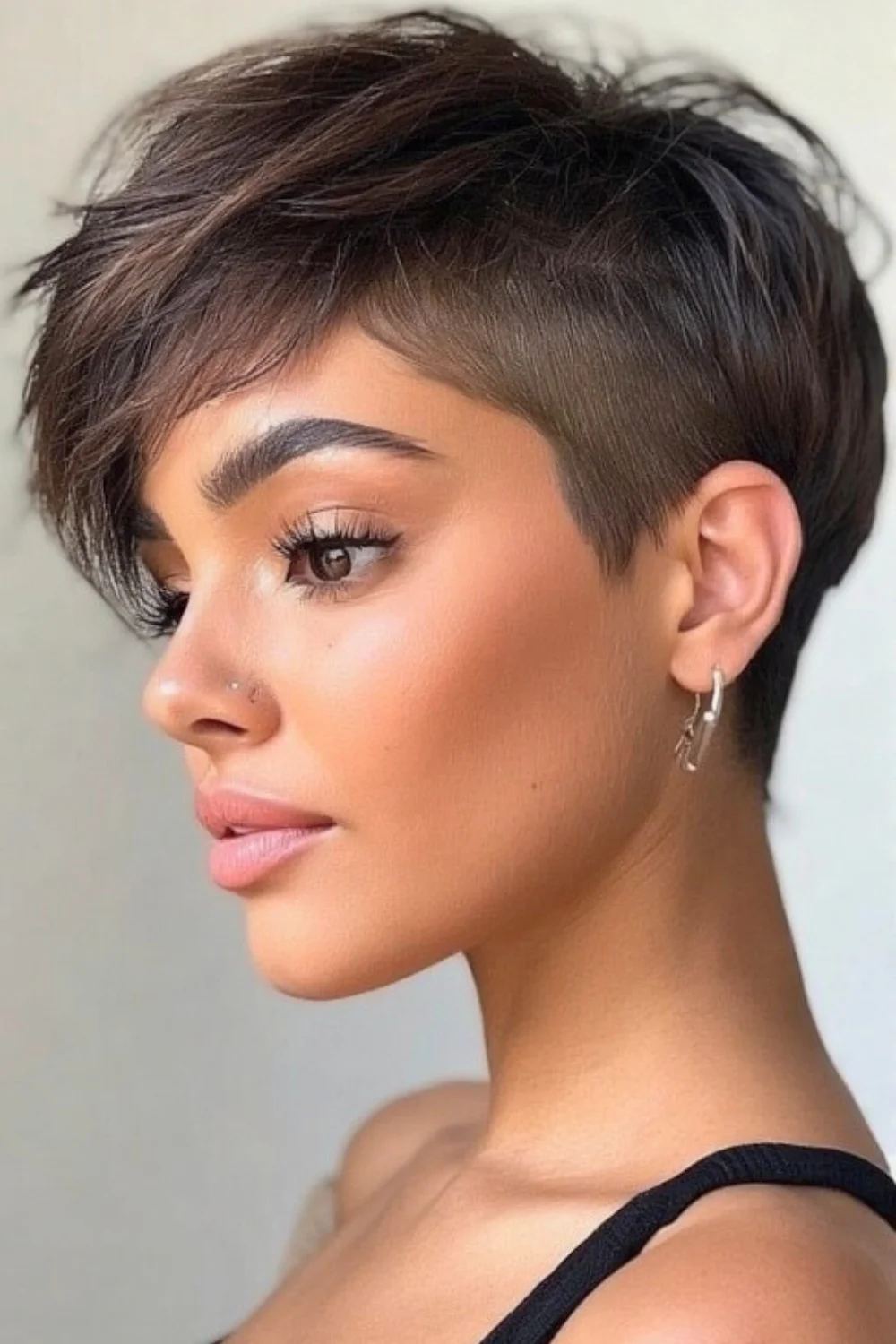 Razored pixie bob haircut with a textured, edgy finish. 