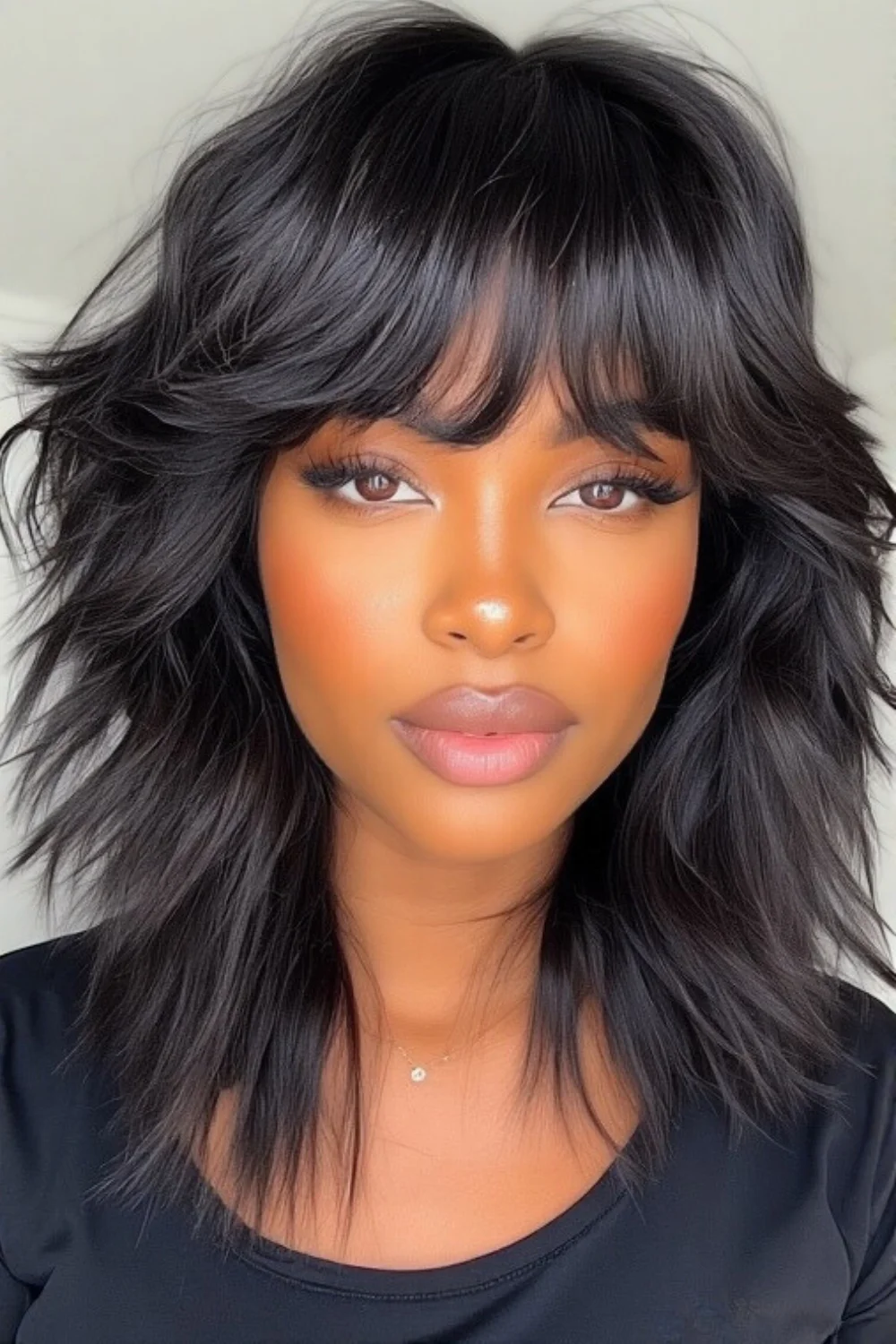 Shaggy layered haircut complemented by bangs