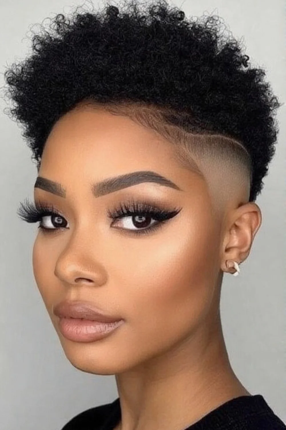 Short afro hairstyle with cleanly shaved sides 