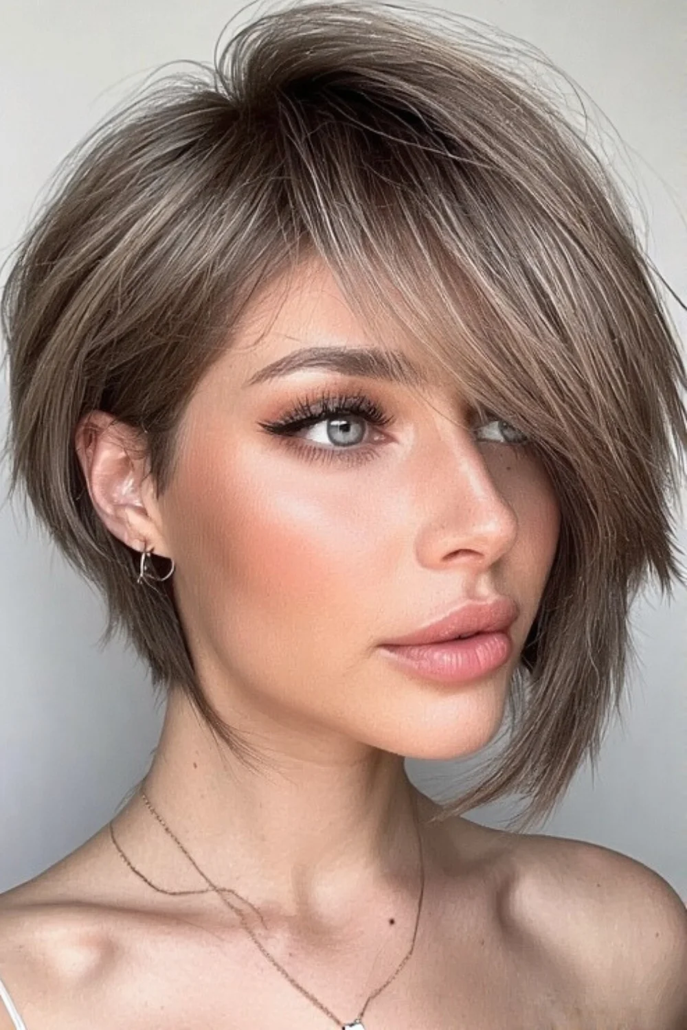 Soft layered pixie bob haircut for a gentle and flowing style. 
