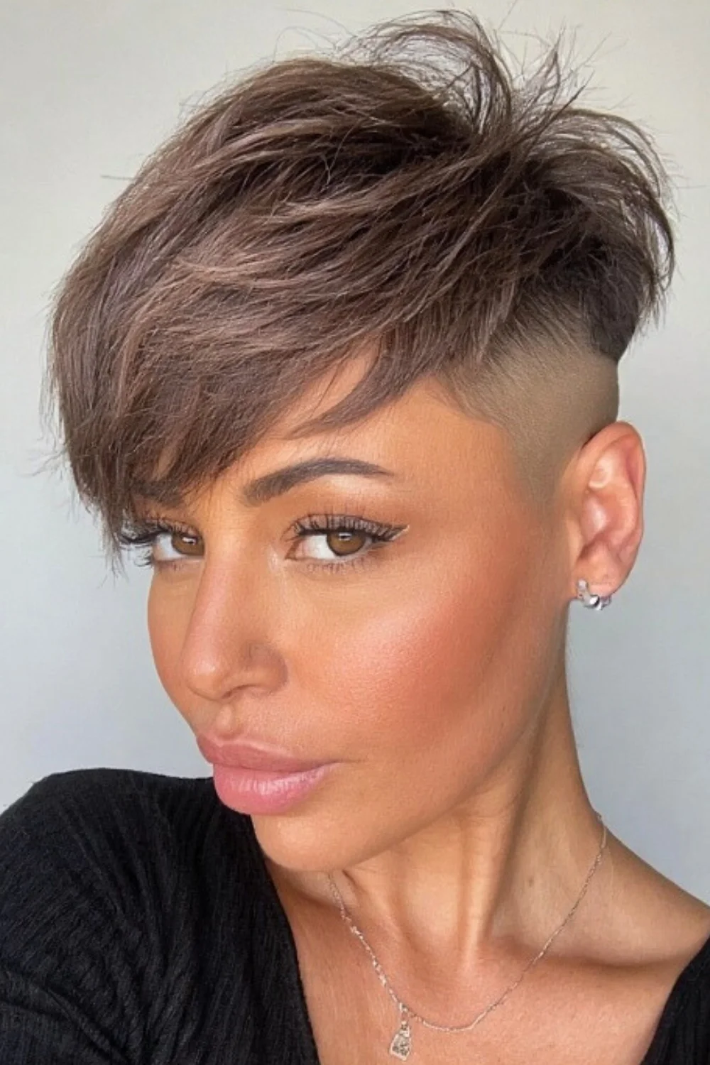 Trendy undercut pixie bob haircut with sharp edges
