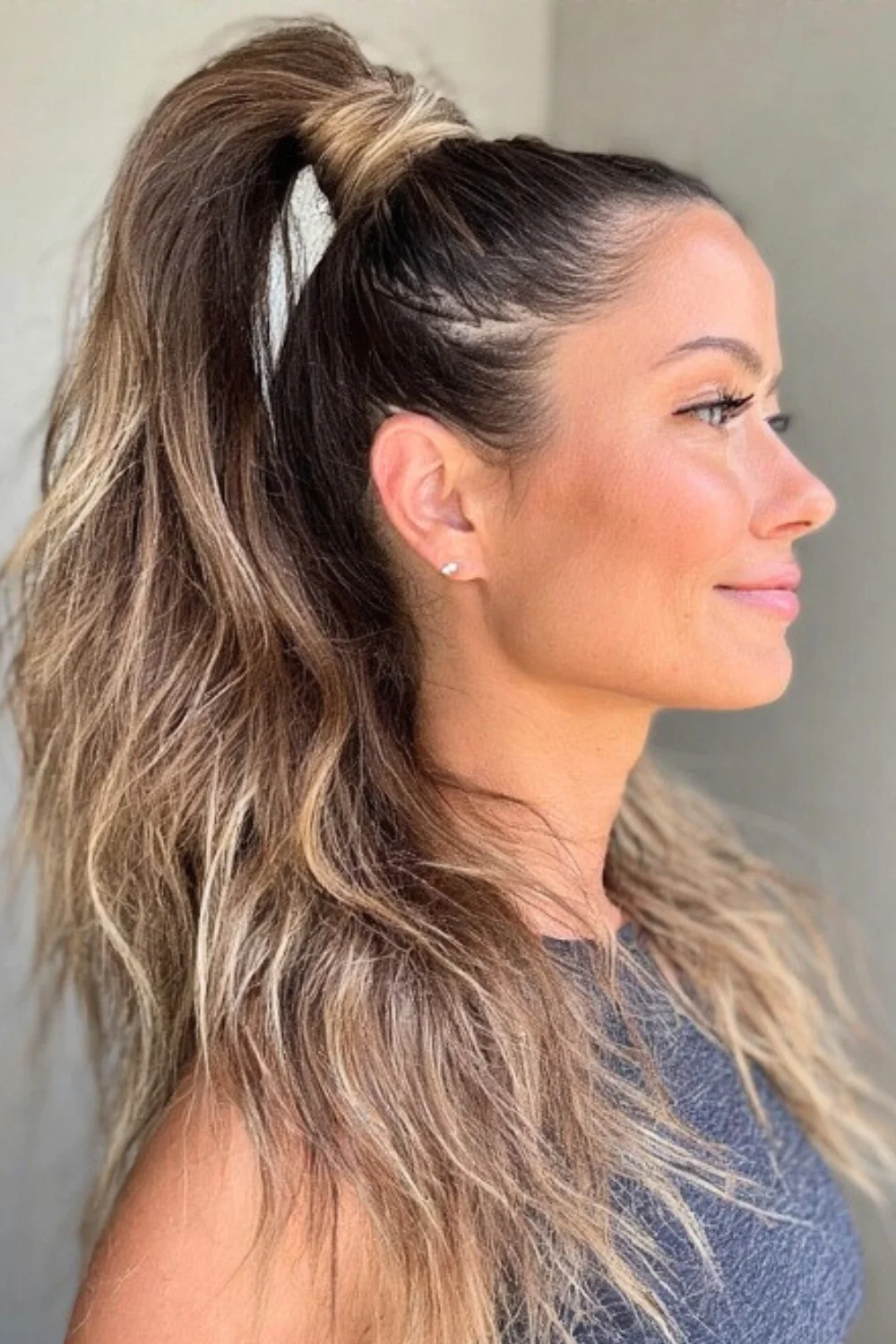 High ponytail hairstyle with added volume and drama
